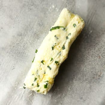 A log of garlic butter with chives.