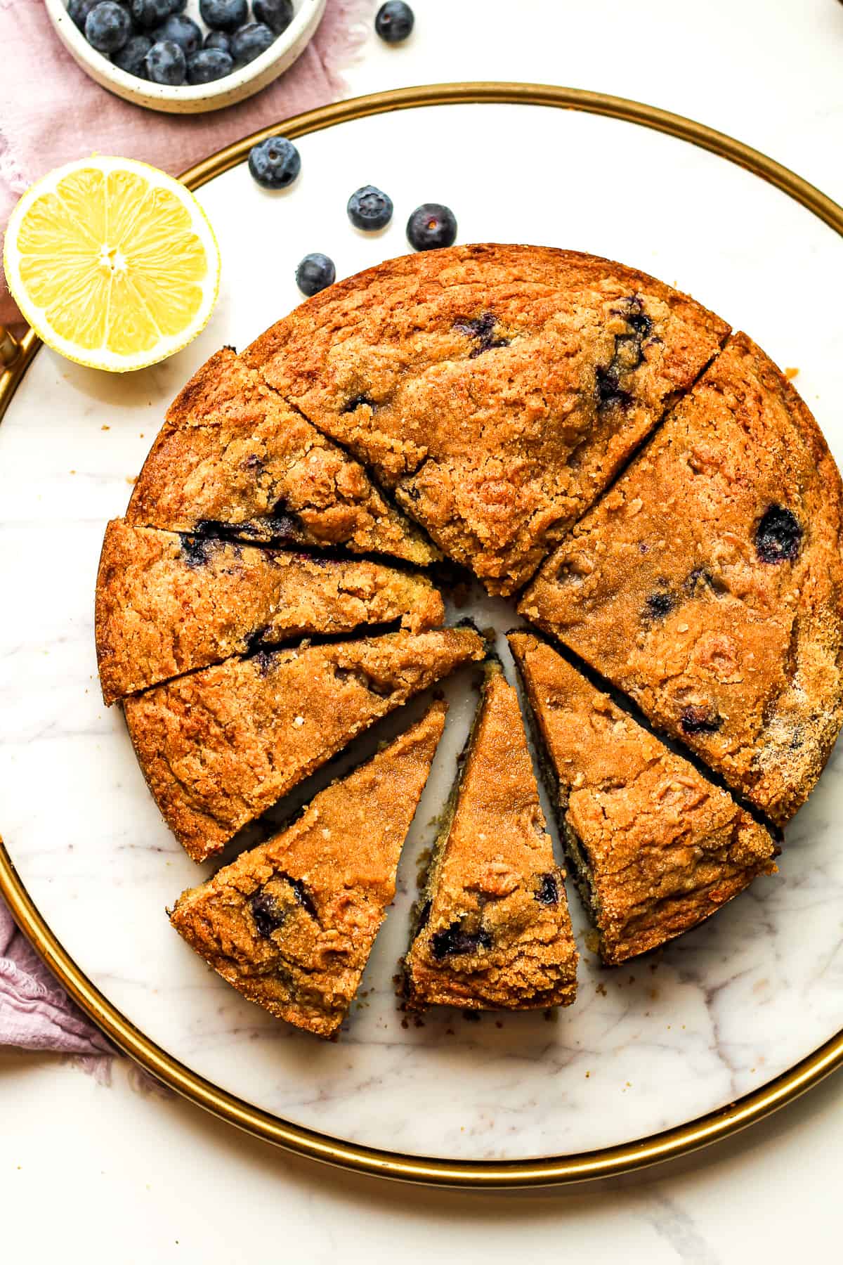 A round platter of a blueberry coffee cake.