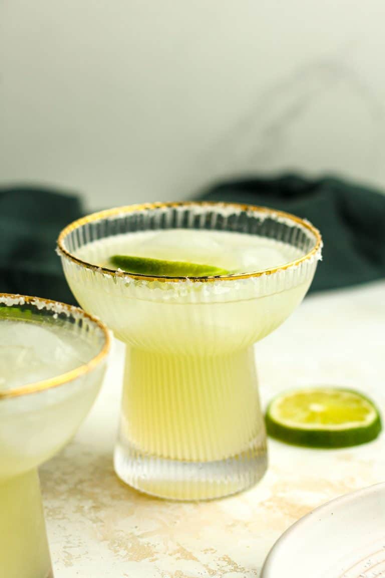 Side view of a skinny margarita with lime.