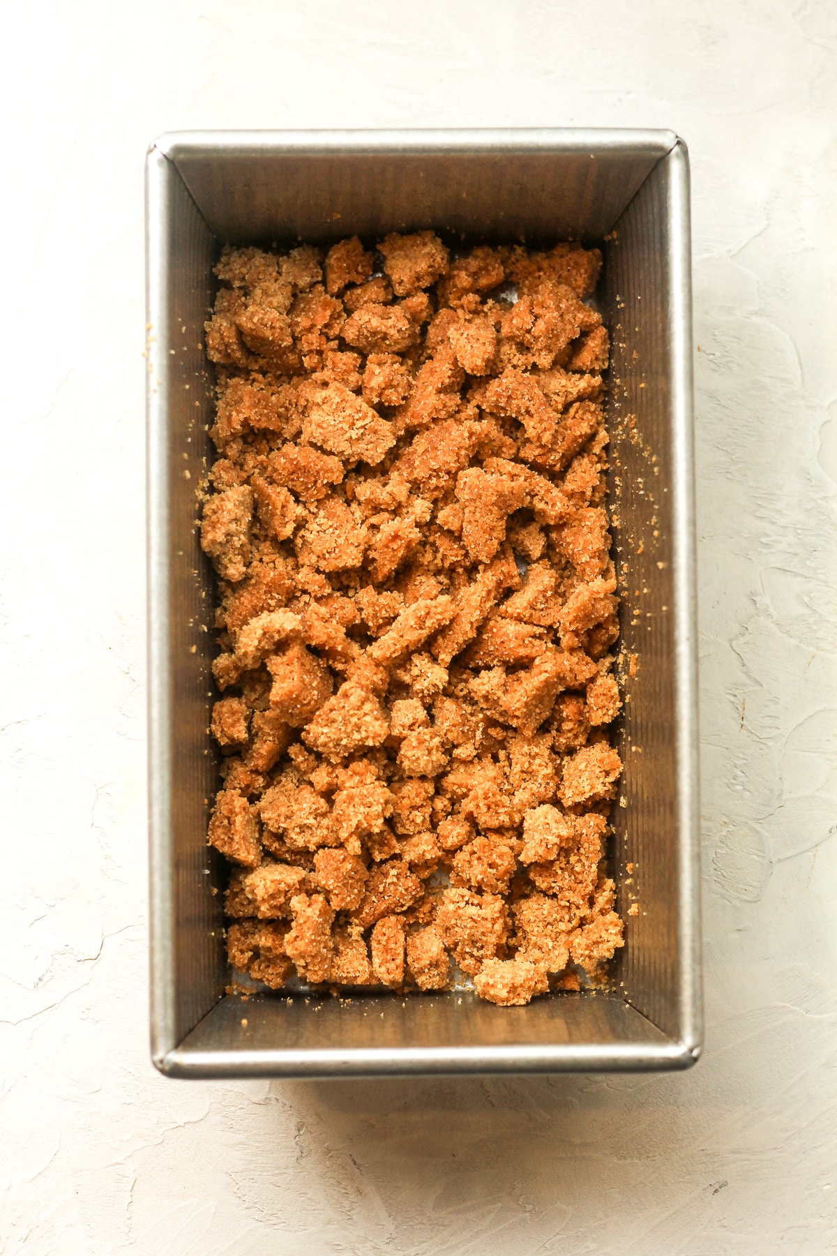 A loaf pan of the graham crumbles.