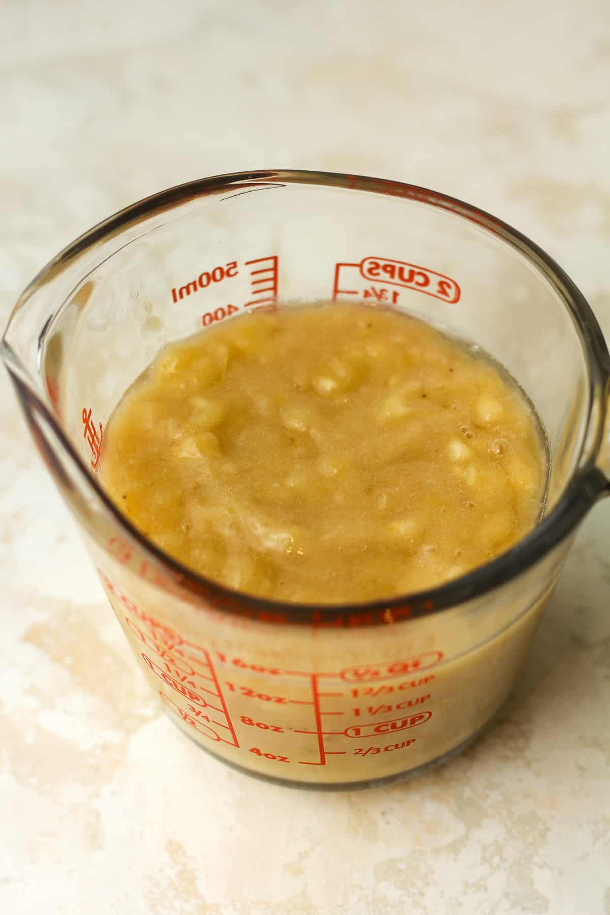 a measuring cup of the pureed bananas.