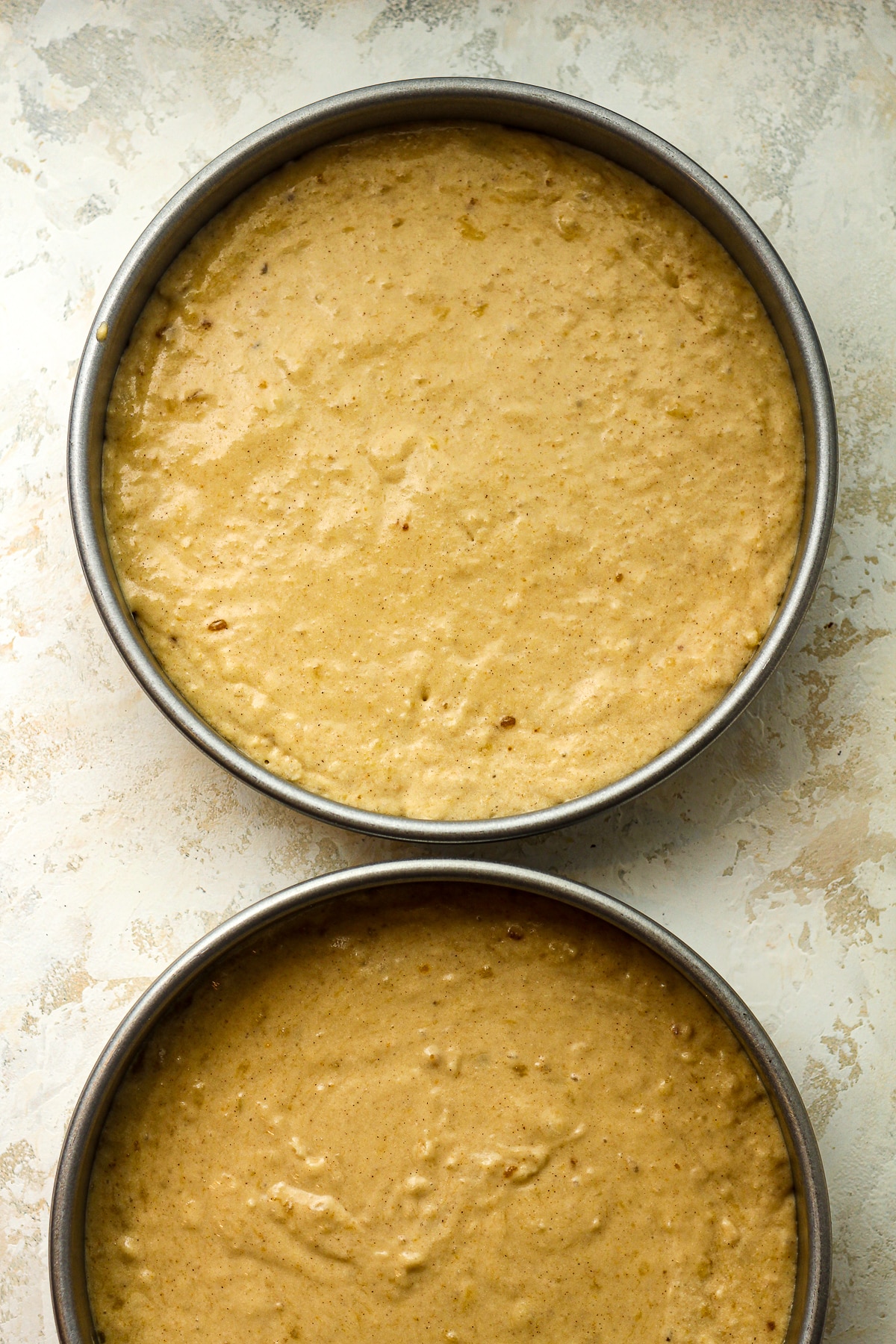 Two round pans of the cake batter.