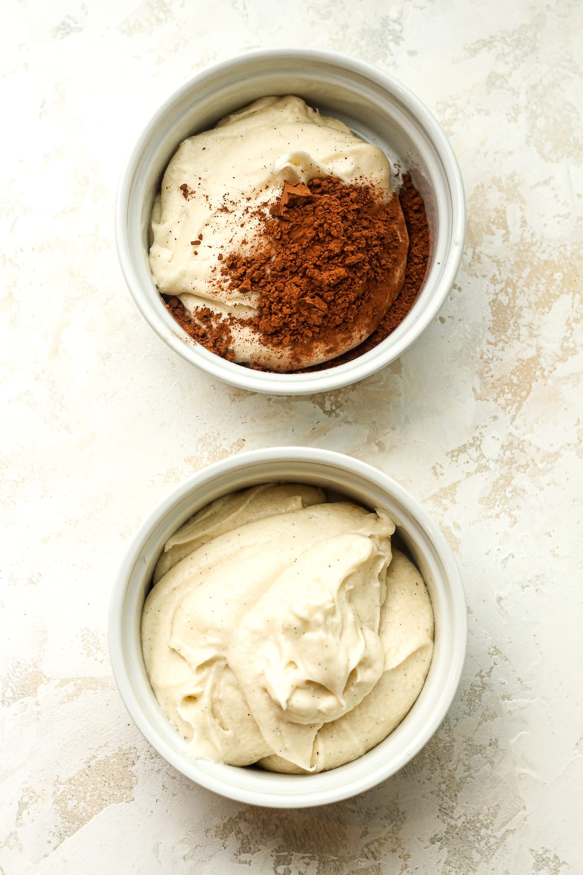 Two bowls - vanilla buttercream and chocolate buttercream.