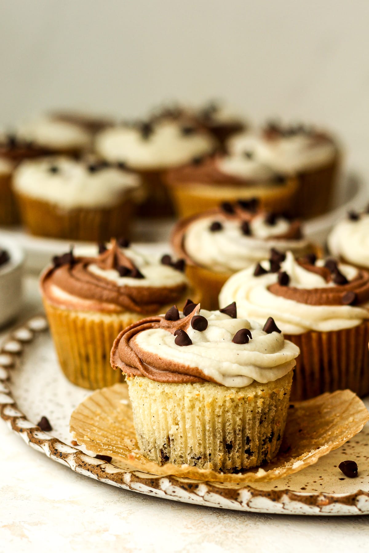 Side view of two plates of cupcakes with mini chocolate chips.