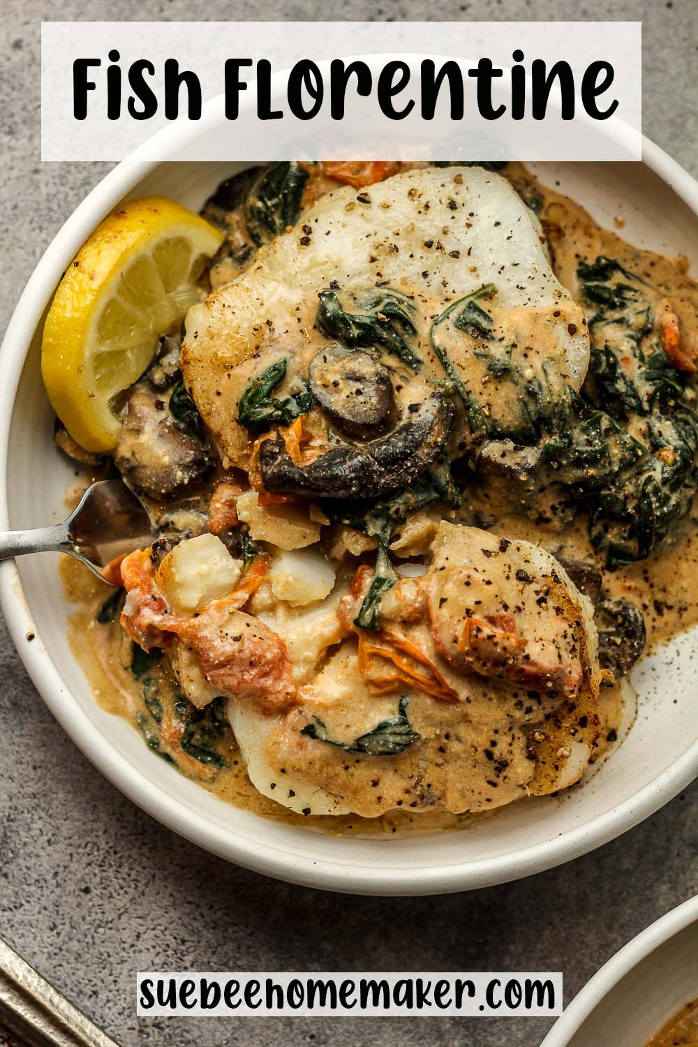 A plate of two pieces of fish Florentine and a creamy sauce.
