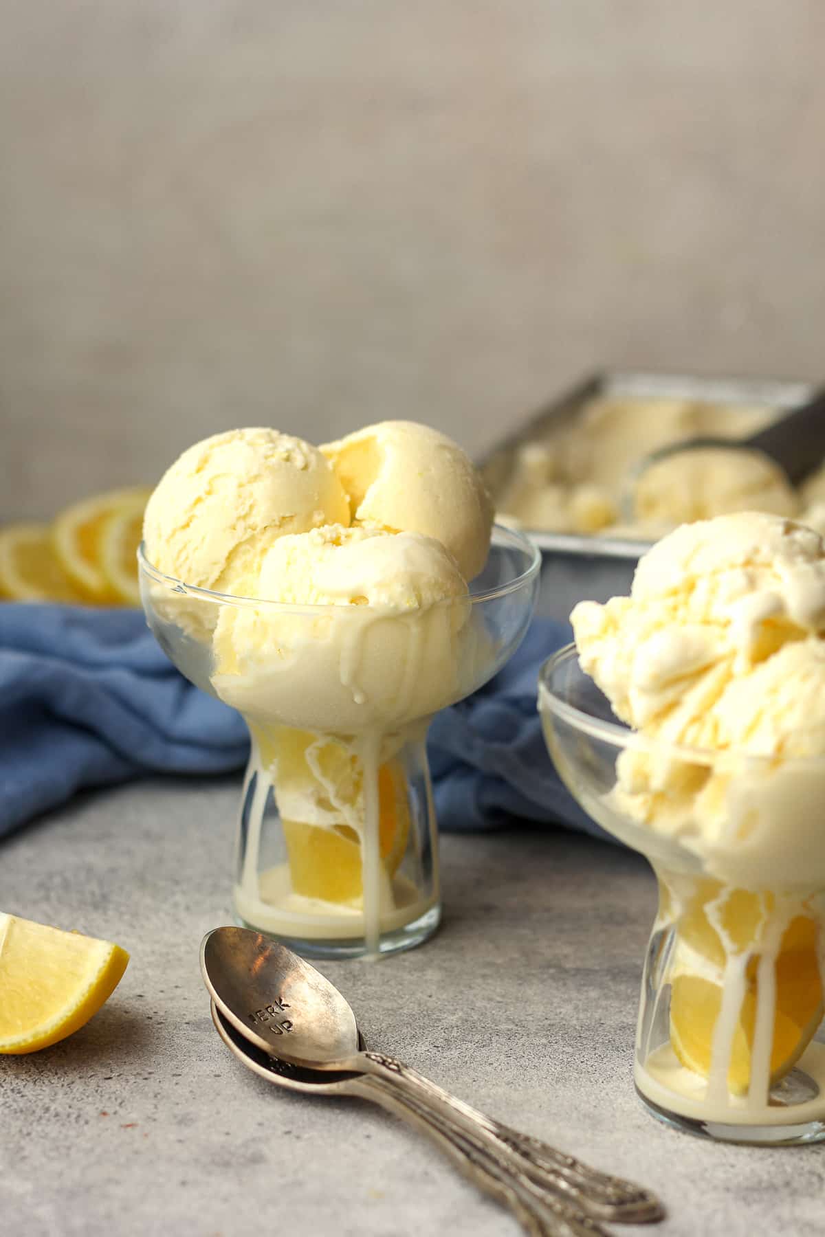 Side view of two bowls of lemon ice cream.