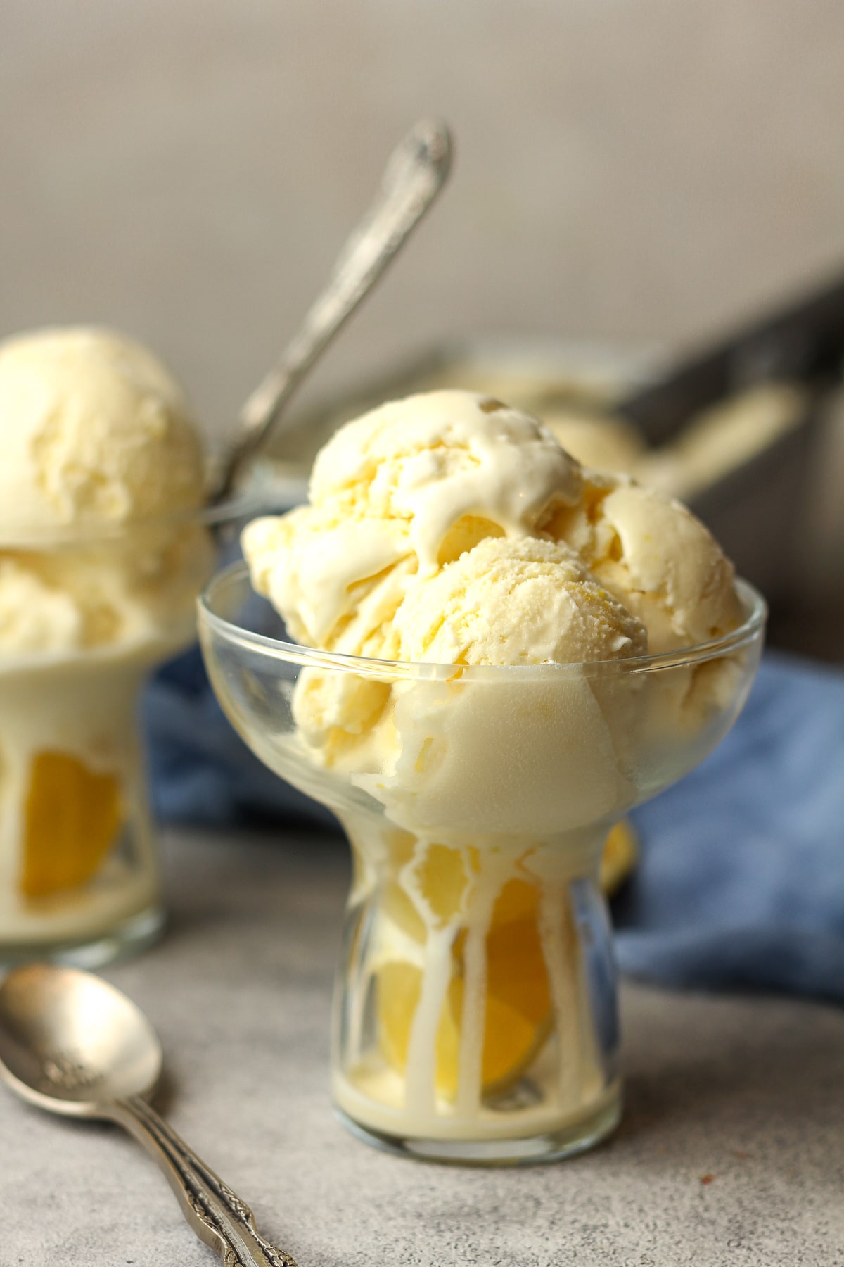 Side view of two bowls of lemon custard ice cream.
