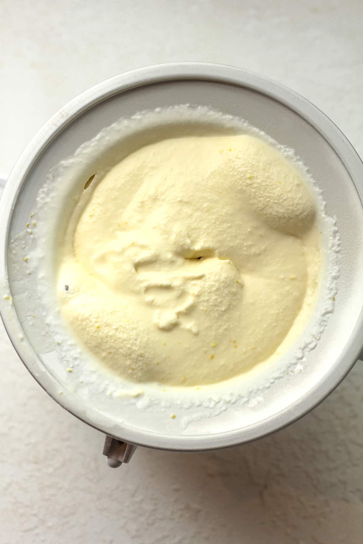 An ice cream churner of lemon ice cream.