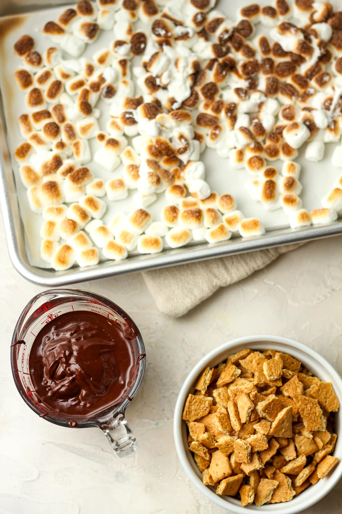 The s'mores mix-ins - toasted marshmallows, melted chocolate, and graham cracker pieces.