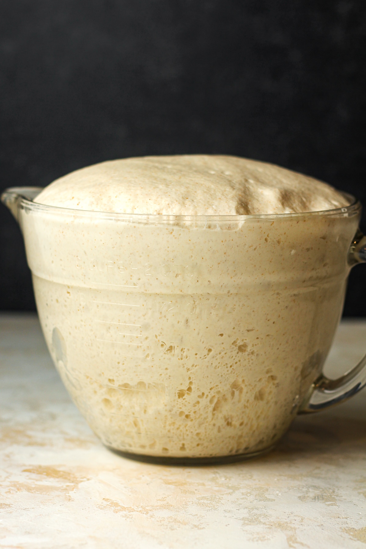 A large measuring cup of the sourdough.