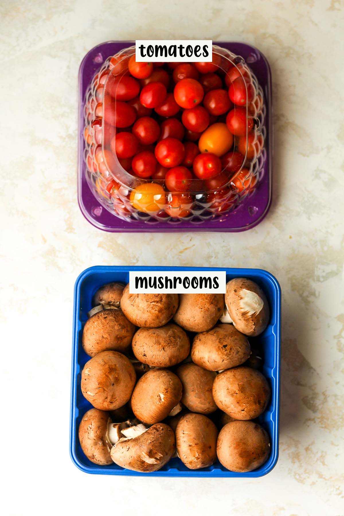 A container of tomatoes and mushrooms.