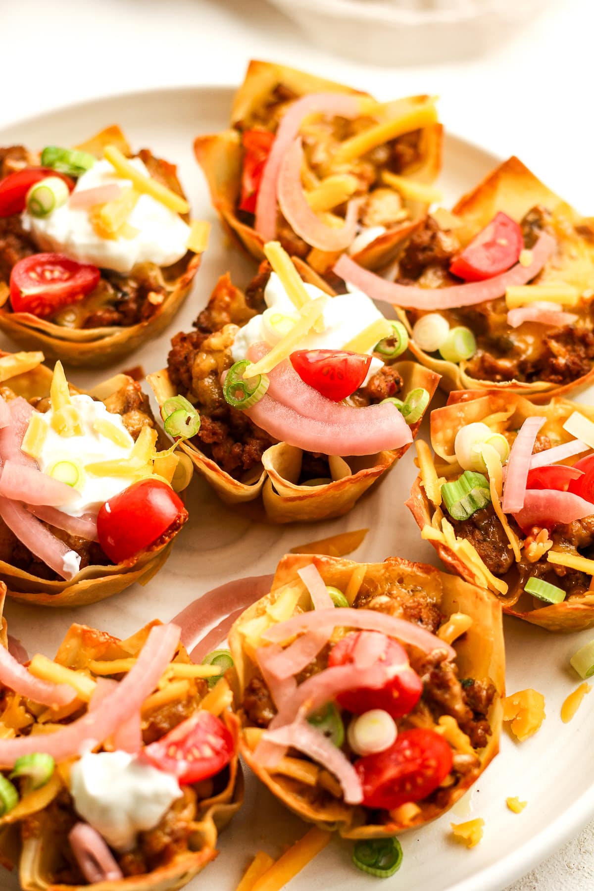 Side view of a plate of taco cups.
