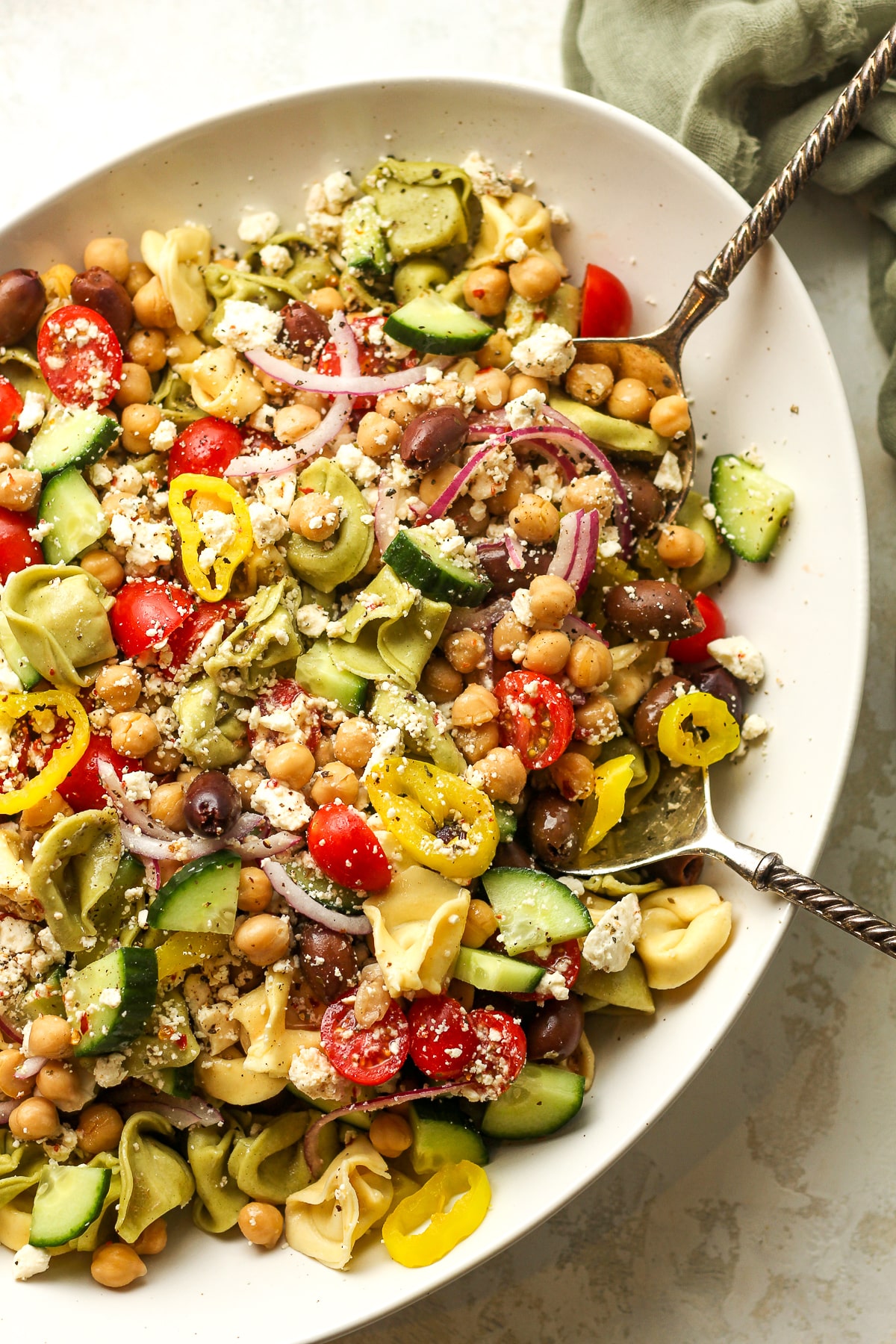 A partial bowl of pasta salad with veggies.