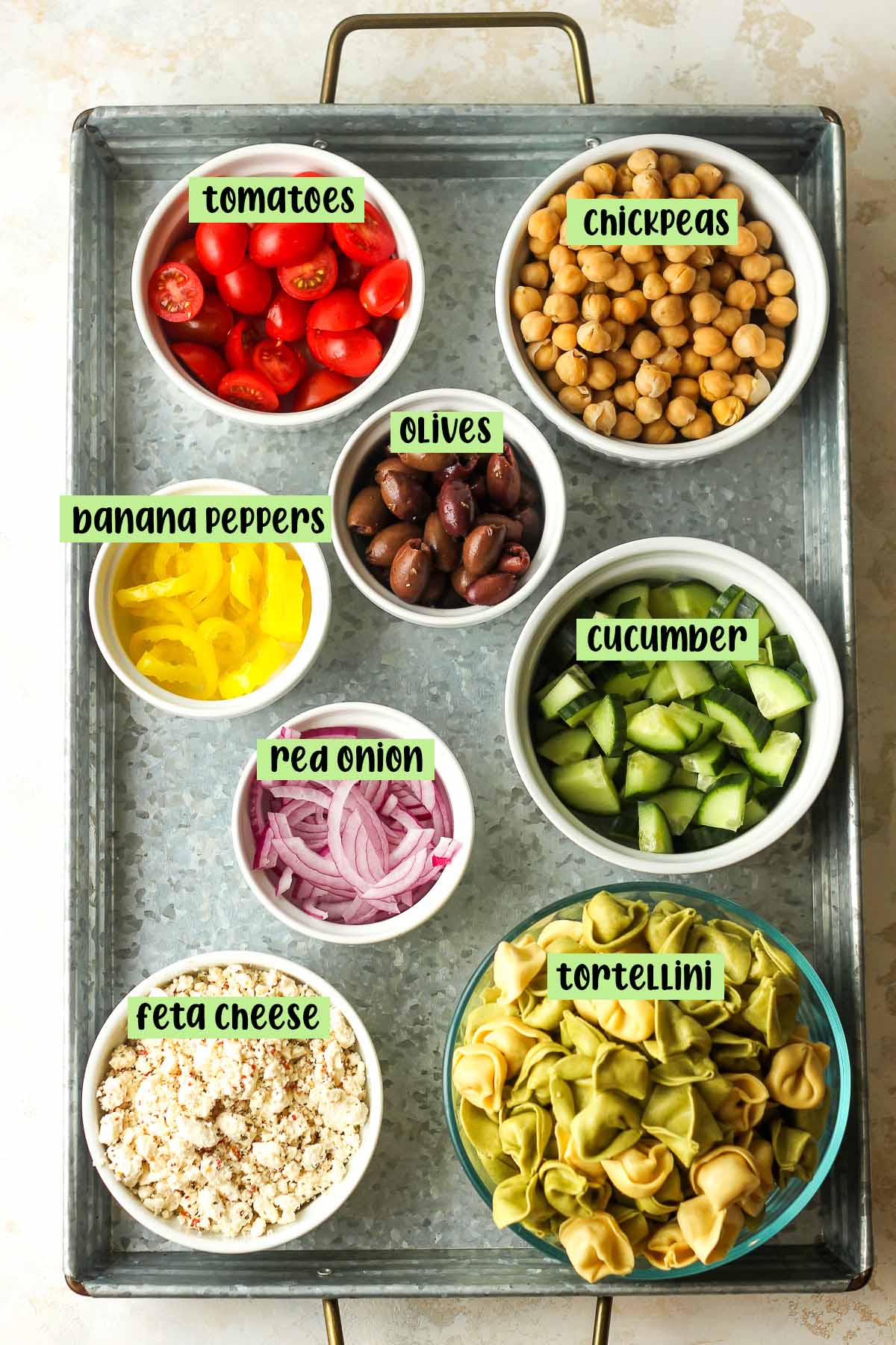 A tray of small bowls with labeled ingredients.