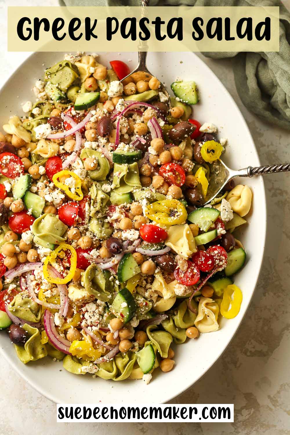 An oblong bowl of Greek Pasta Salad with chickpeas.