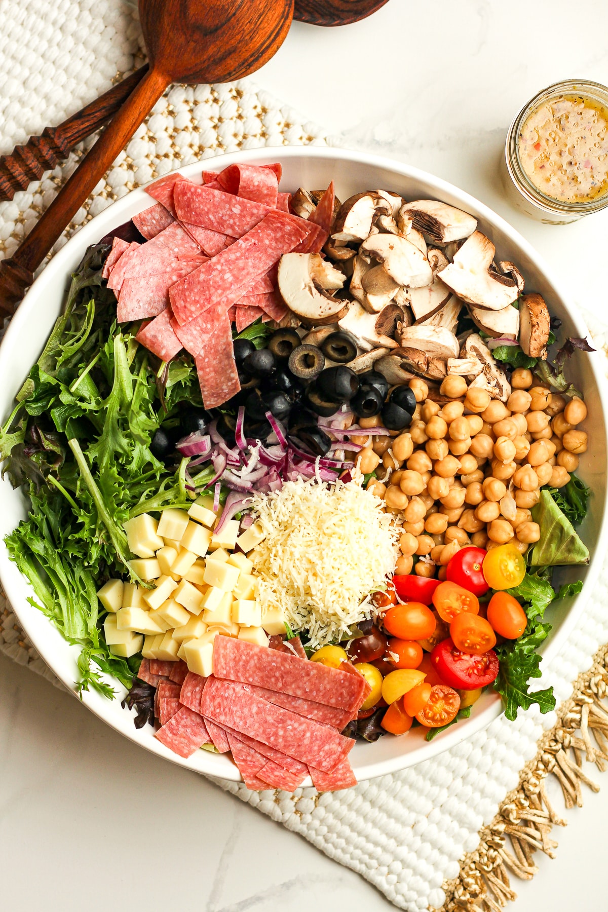 A large bowl of the salad ingredients separated by ingredient.