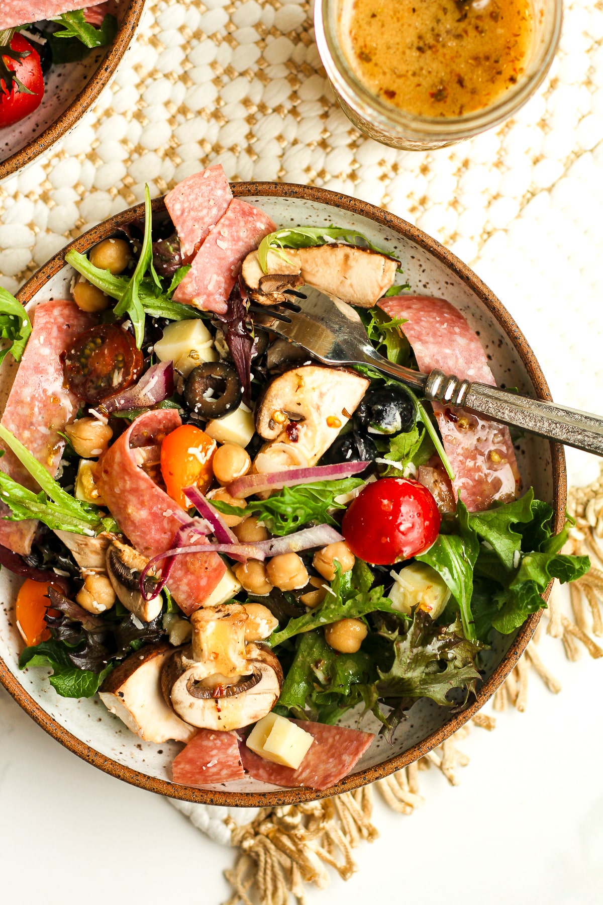 A serving of the antipasto salad with a fork.