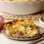 A slice of ham and gruyere quiche.