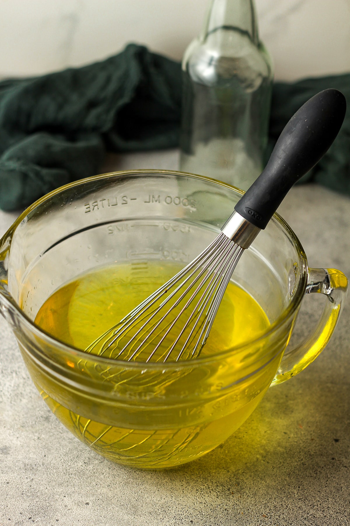 A large measuring cup of the limoncello after adding simple syrup.