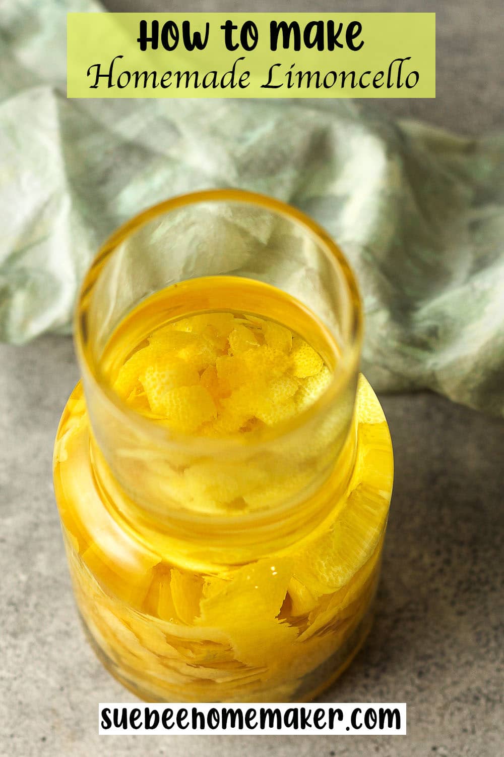 Overhead view of a large jar of lemon-infused vodka.