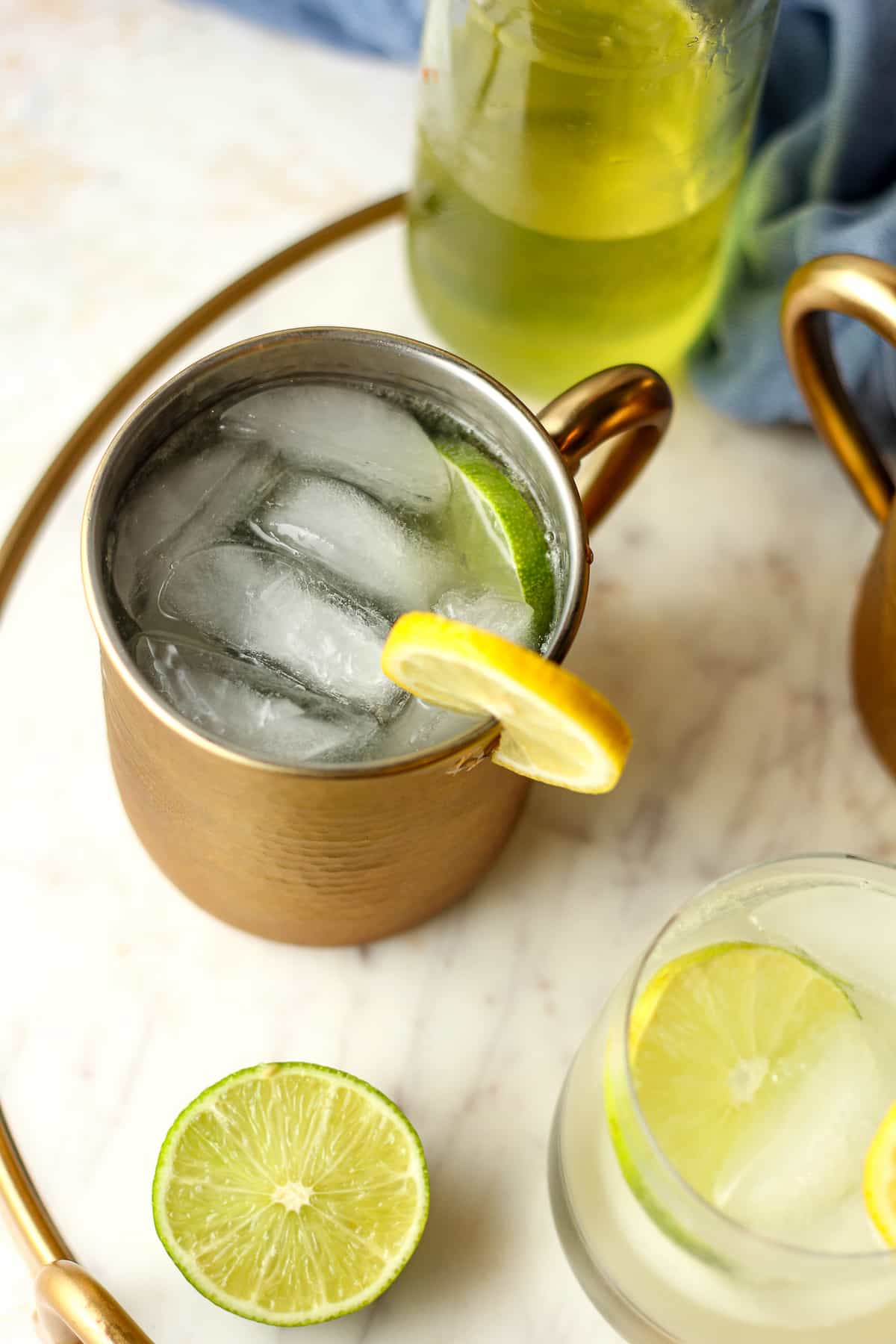 Overhead view of two mugs of limoncello mules.