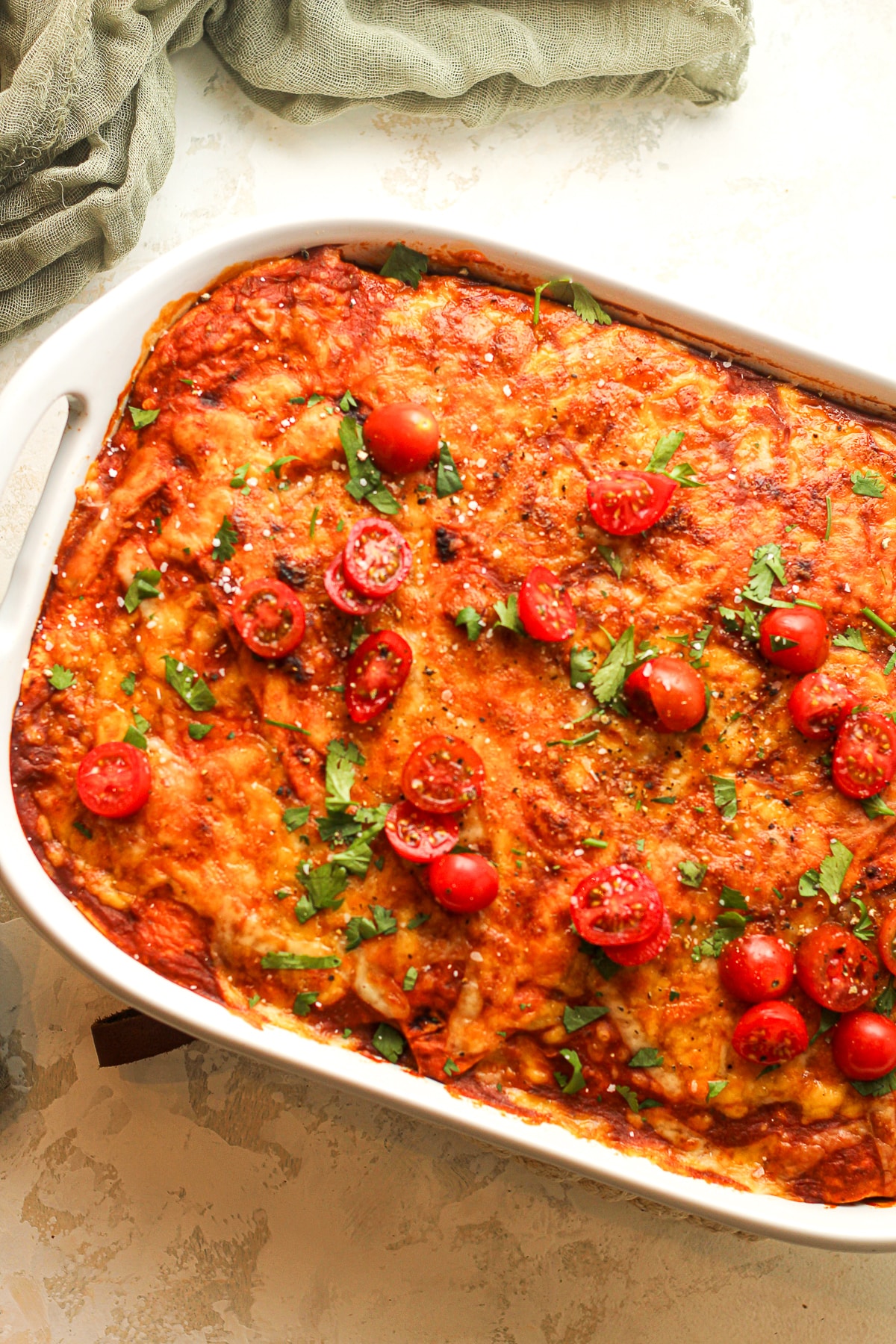 A portion of the casserole with tomatoes on top.