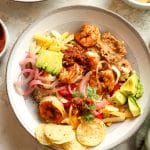 A shrimp taco bowl with chips.