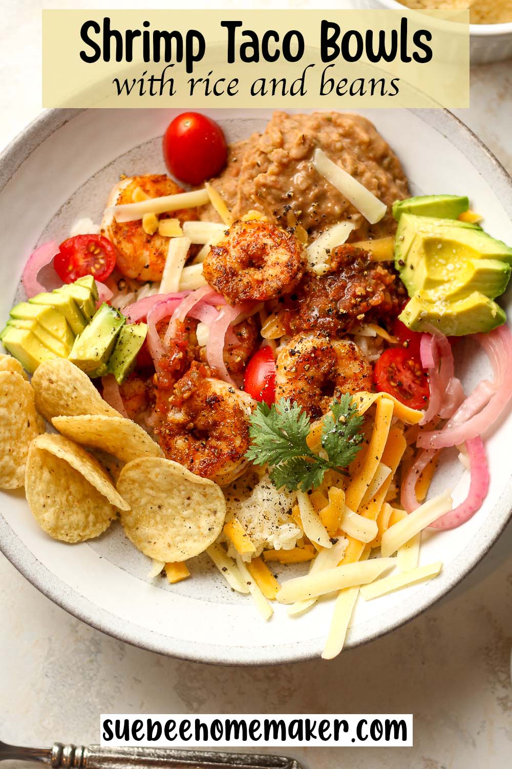 A shrimp taco bowl with rice and beans.