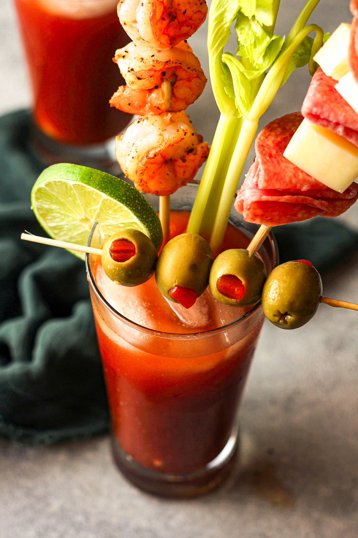 Overhead view of a spicy Bloody Mary with garnishes.