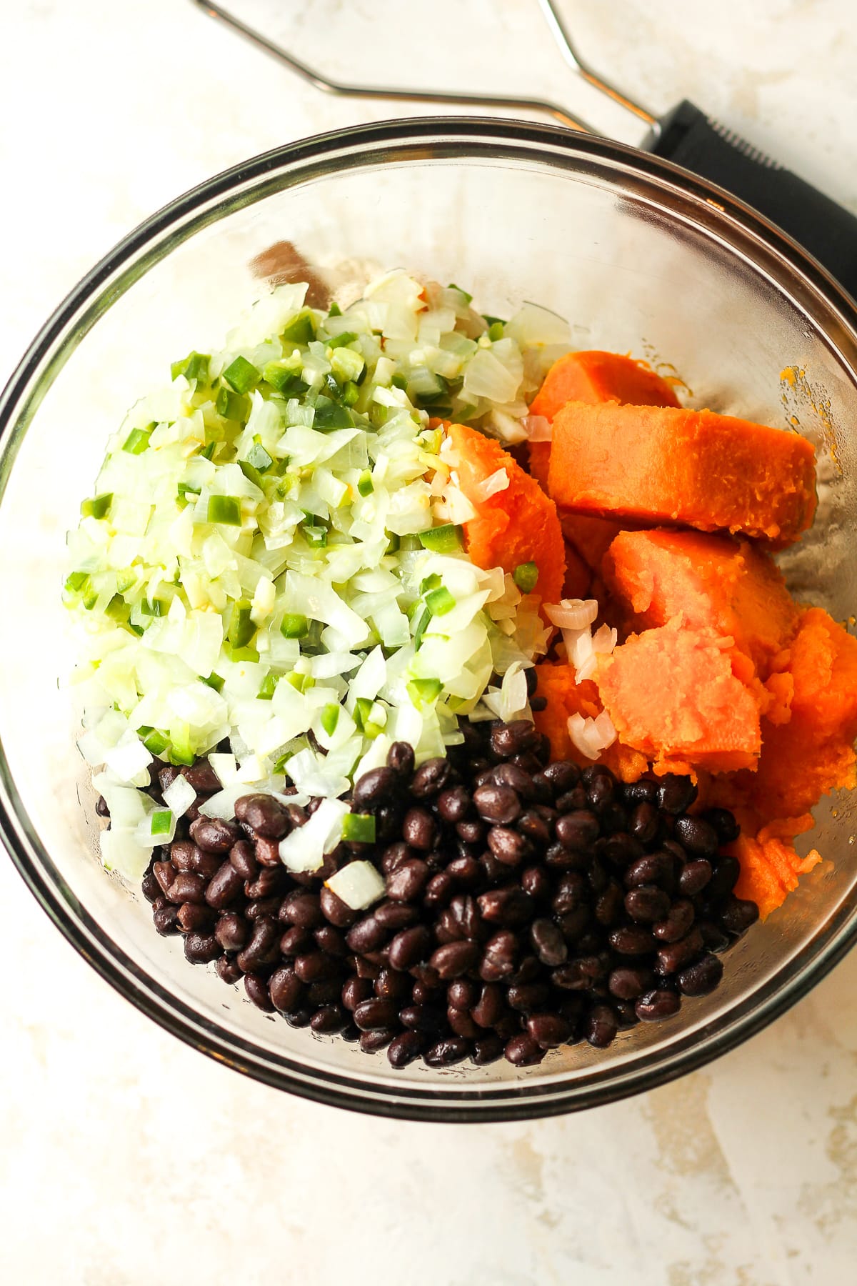 A bowl of the cooked sweet potatoes, sautéed veggies, and black beans.