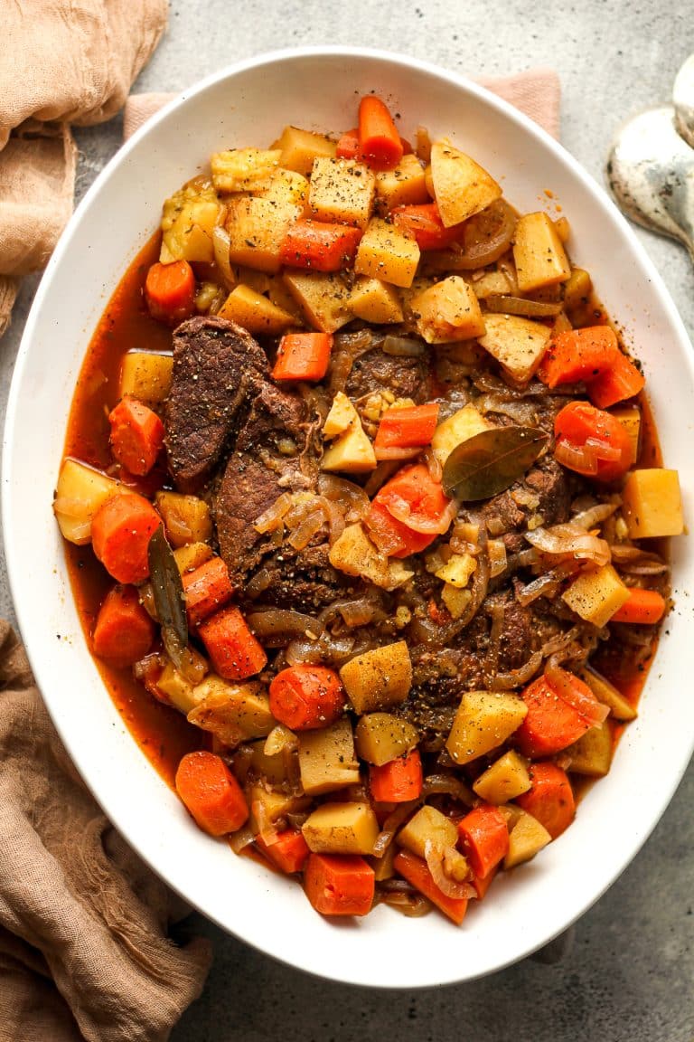 An oblong platter of the just cooked pot roast and veggies.