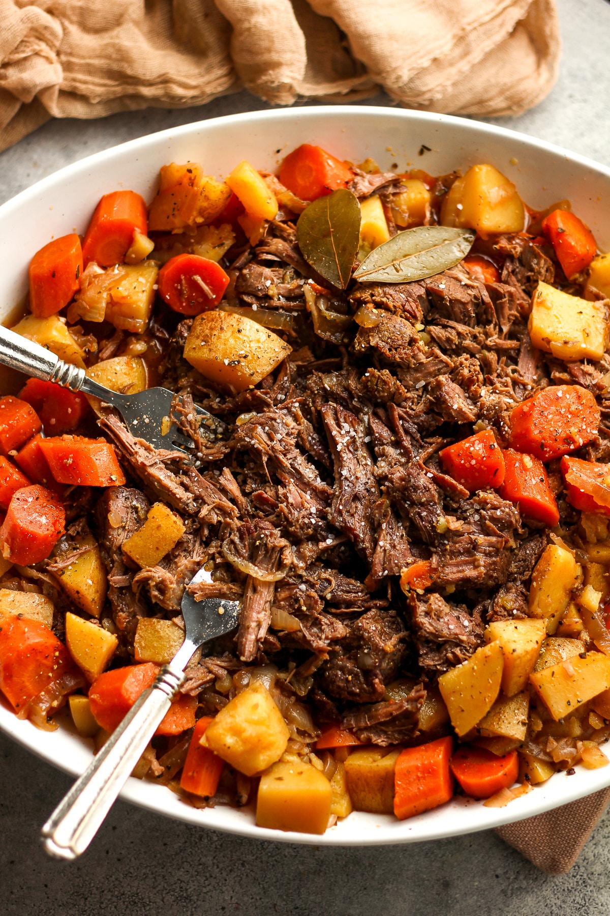 A serving platter of the shredded roast with veggies.