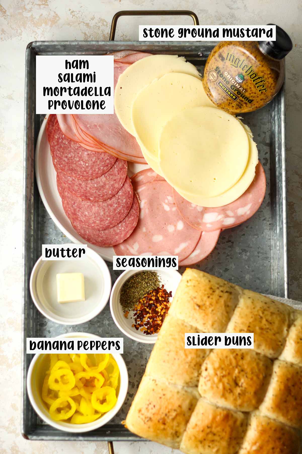 A tray of the ingredients for Italian sliders.