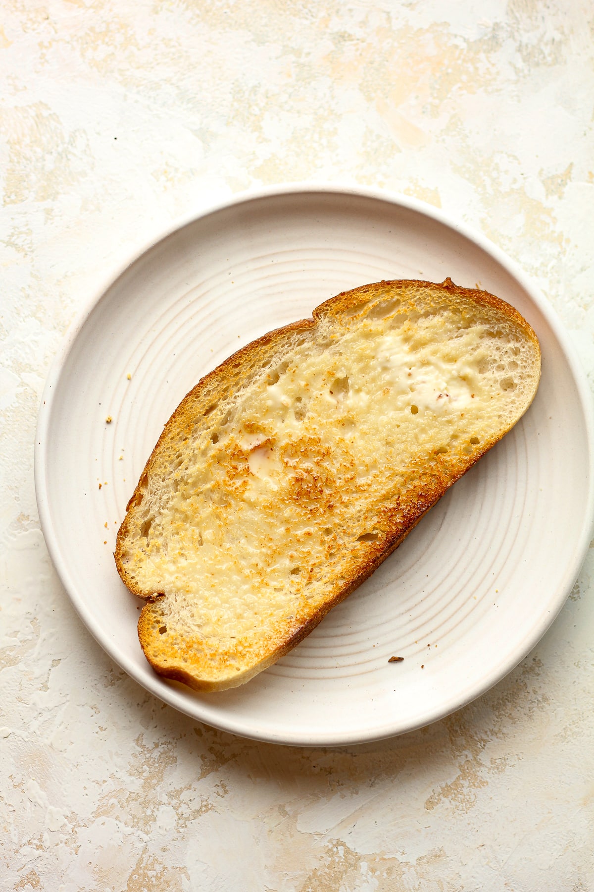 A piece of toast with butter.