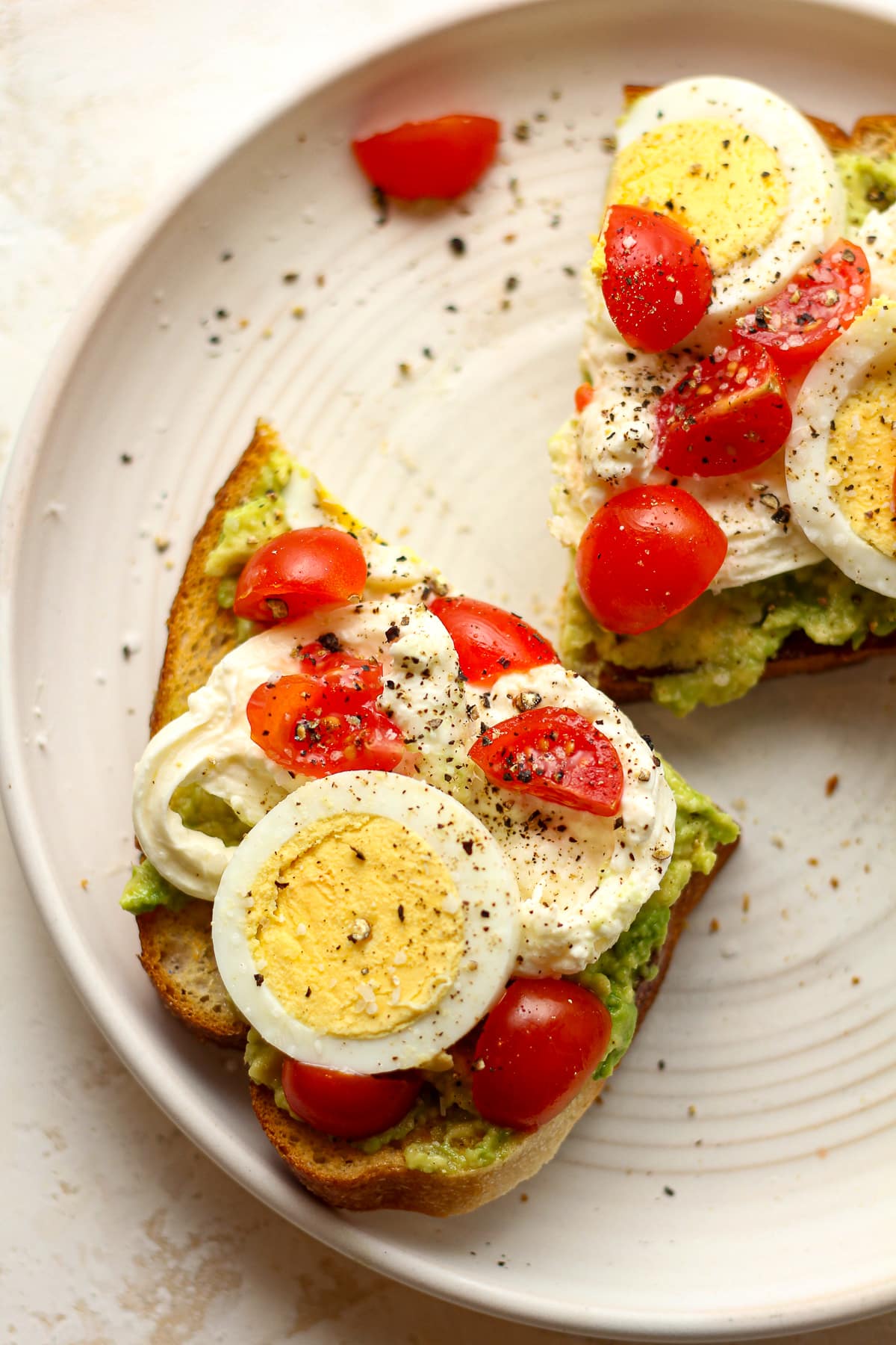 A closeup on a halved piece of burrata toast.