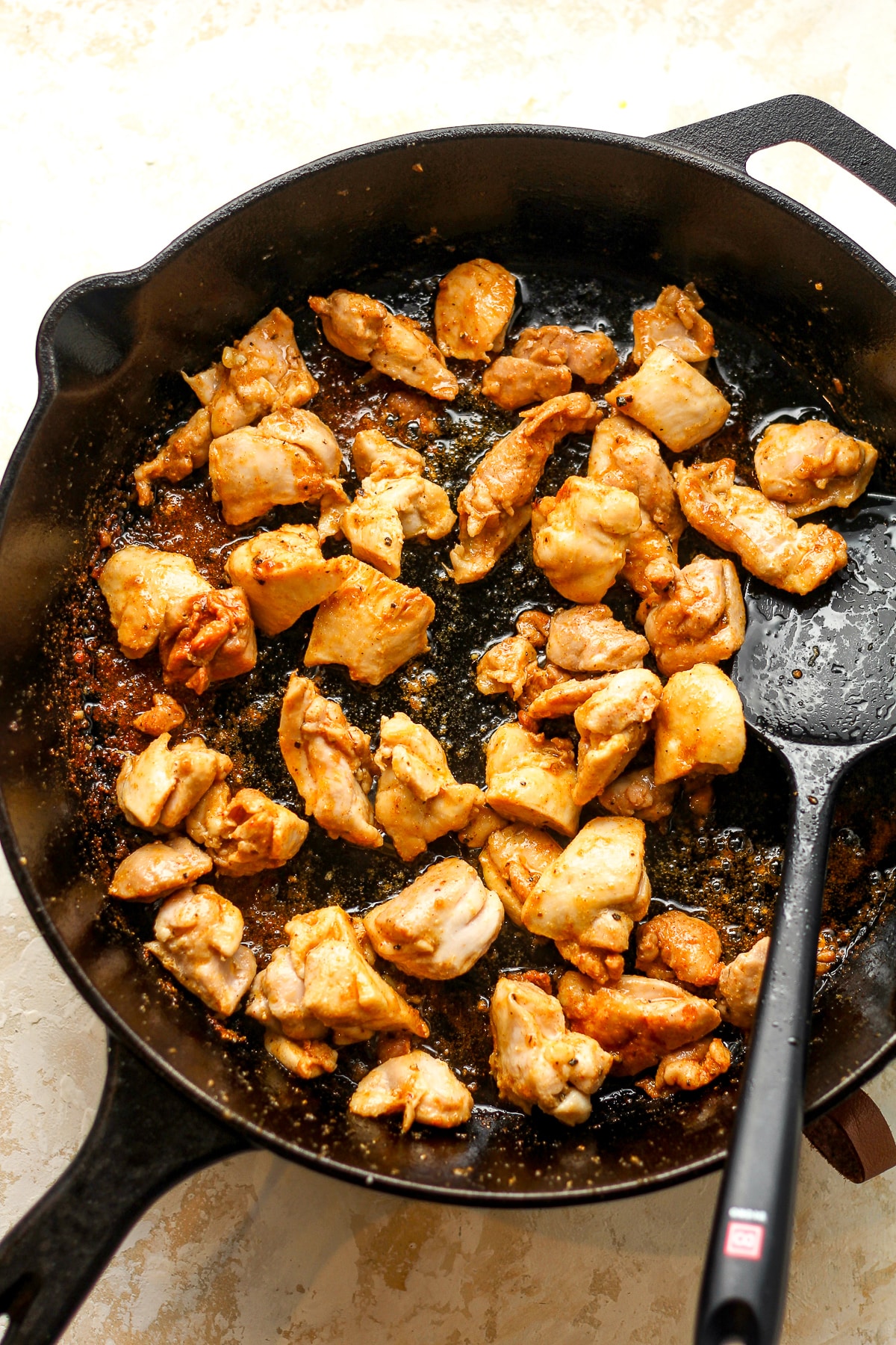 A skillet of the sautéed chicken thighs.