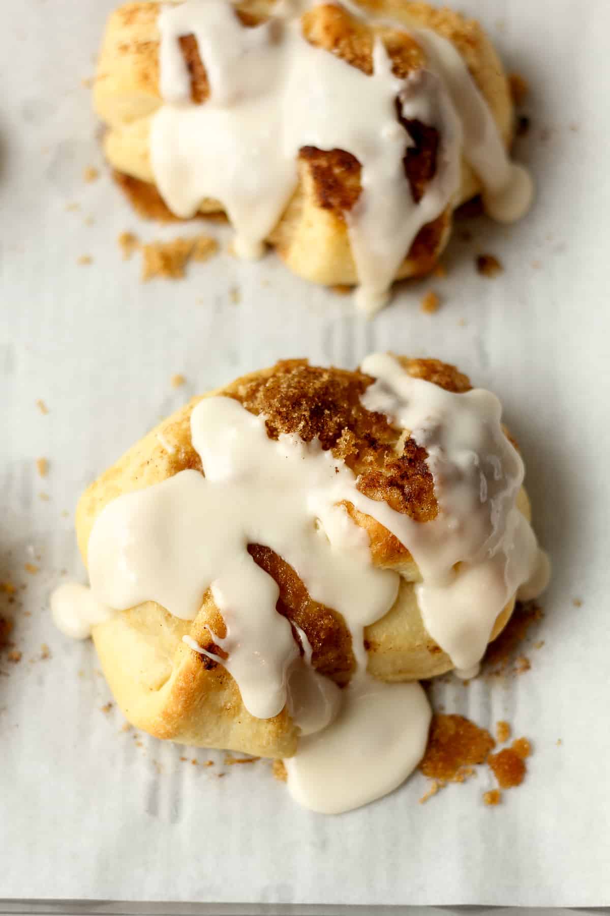 Two iced cinnamon roll knots.