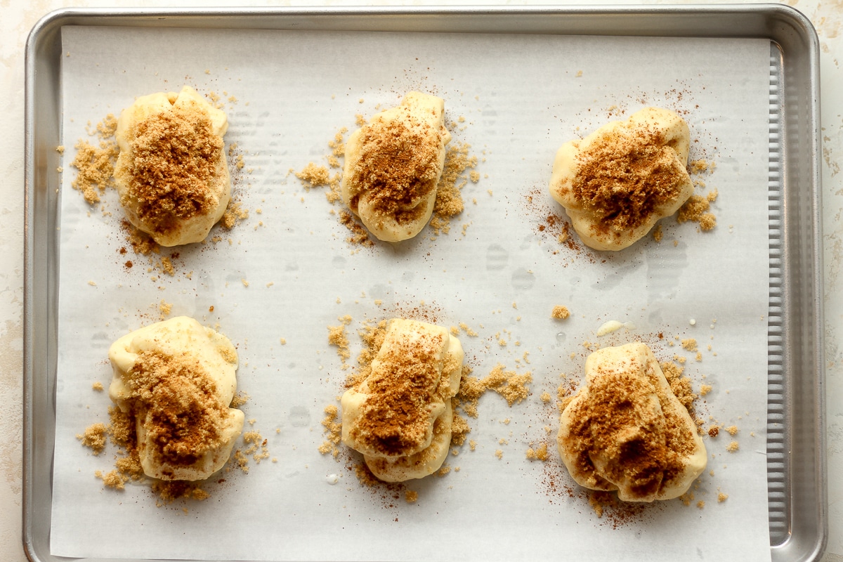 A pan of the cinnamon knots before baking with sugar and cinnamon on top.