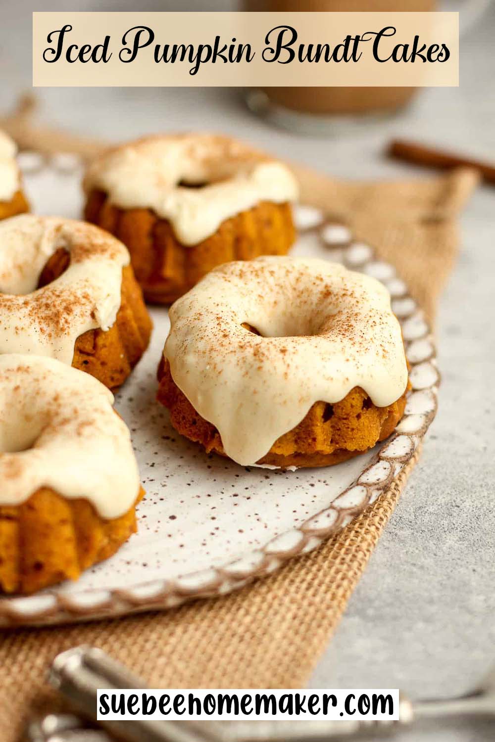 Side view of a plate of iced pumpkin bundt cakes.