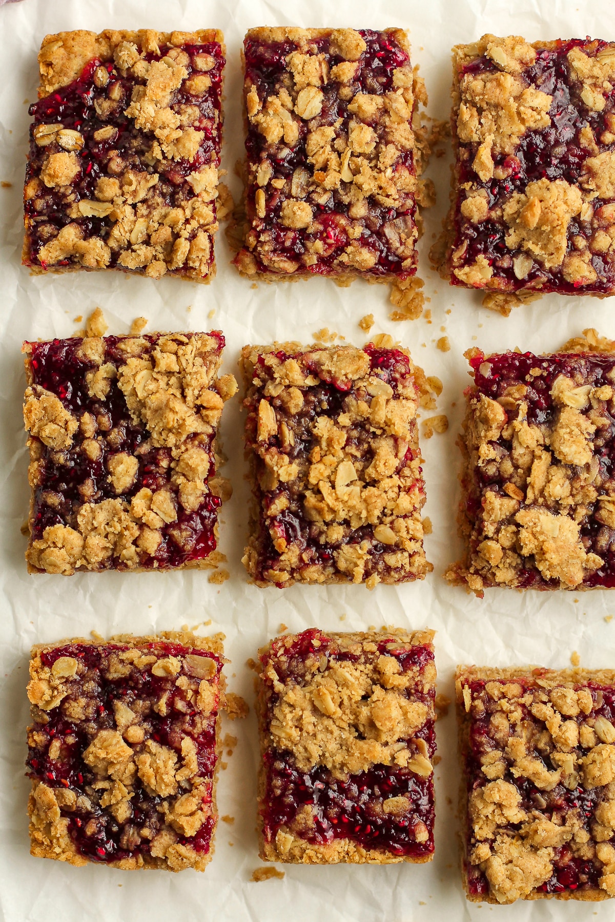 Some sliced jam bars on parchment paper.