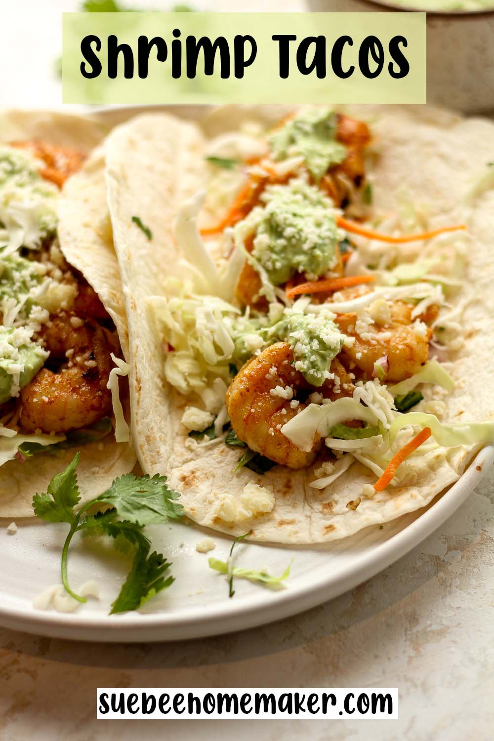 Side view of a plate of shrimp tacos.