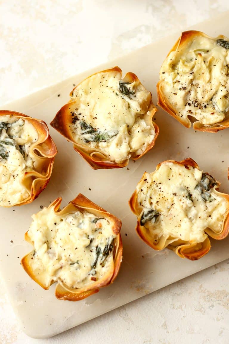 Overhead view of several spinach and artichoke bites.