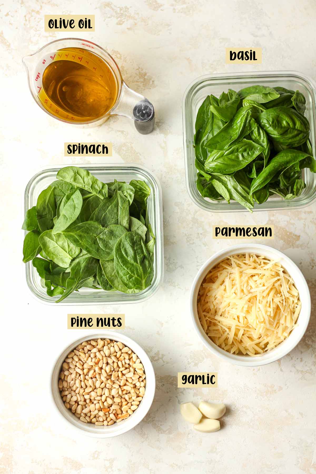 The labeled ingredients for spinach pesto.