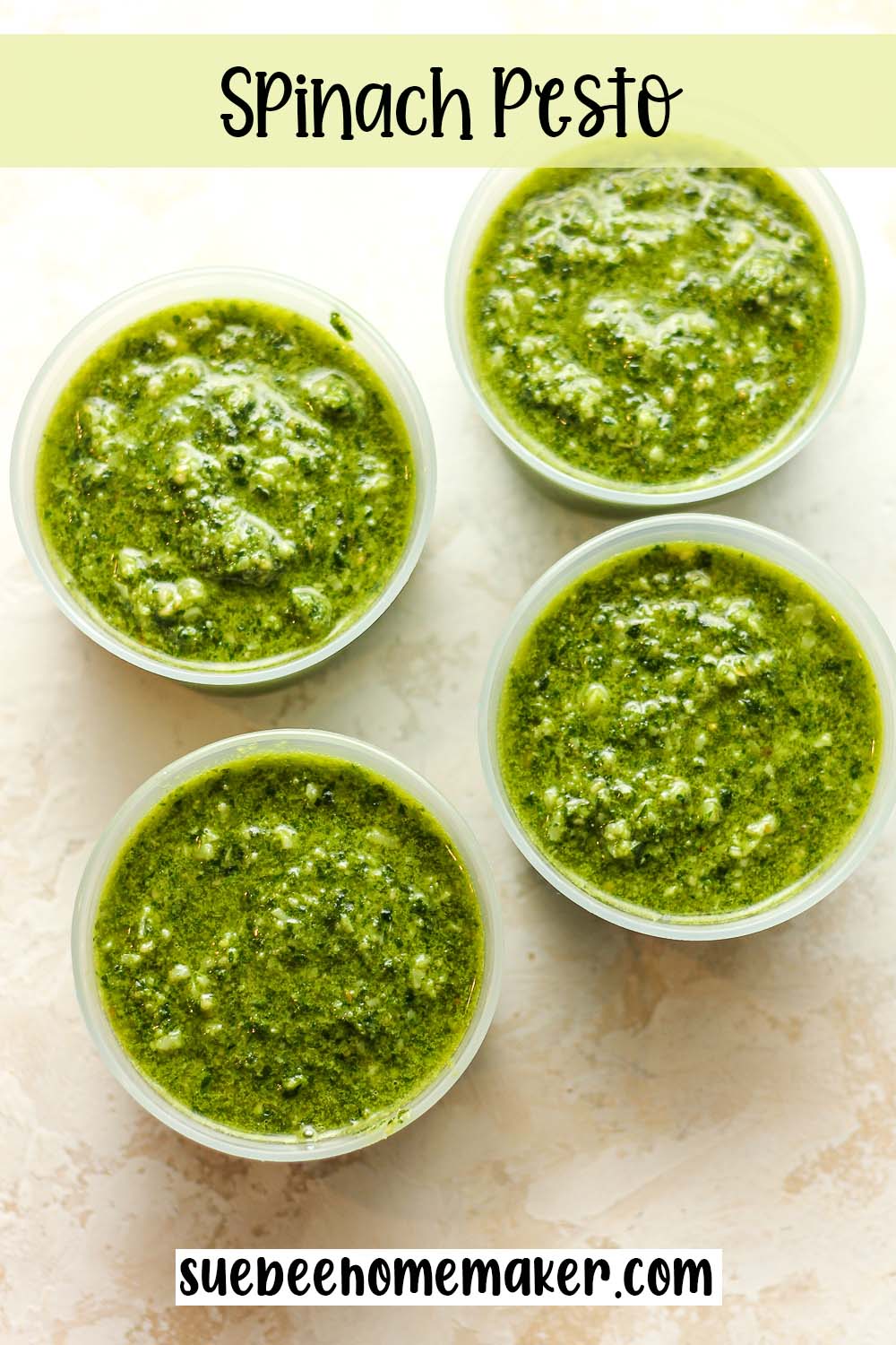 Four small containers of spinach pesto.