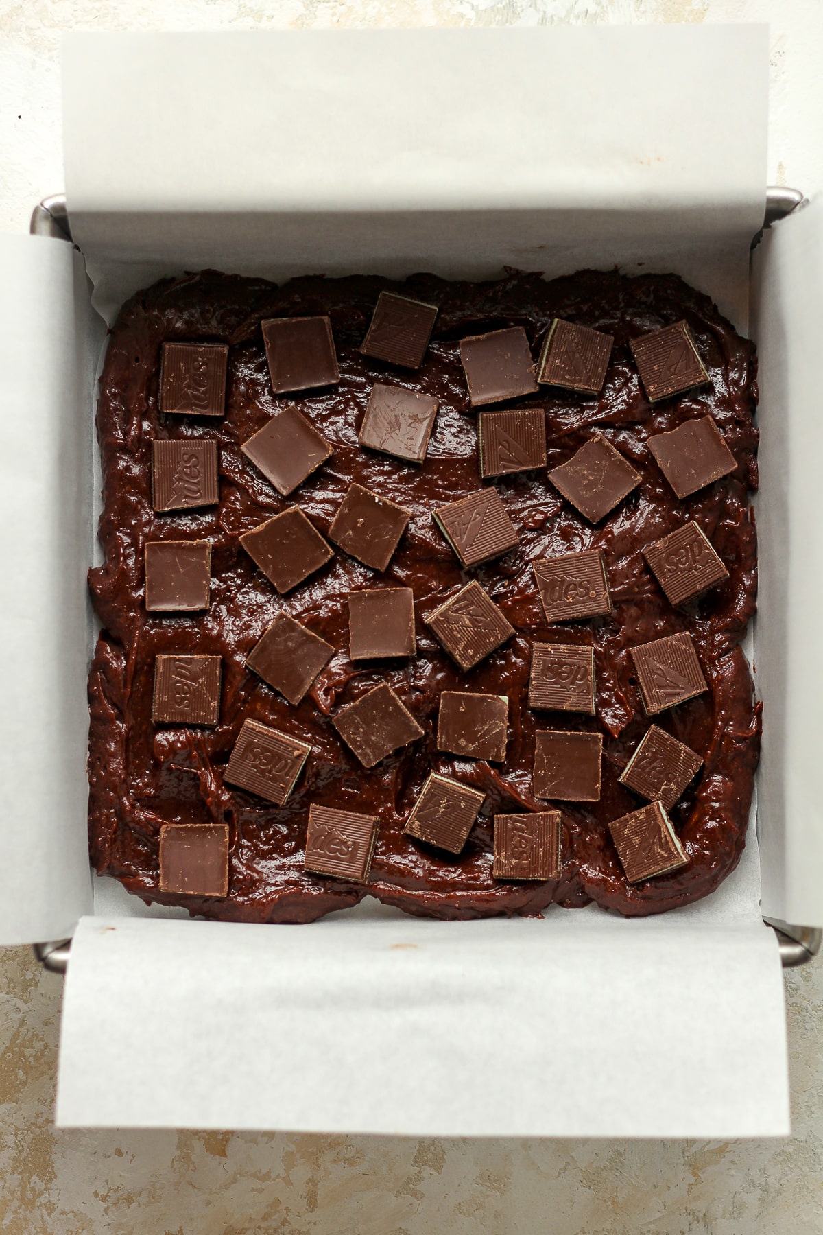 A pan of some of the brownie batter with mints on top.