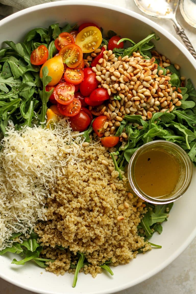 A closeup shot of the arugula salad in a large bowl.