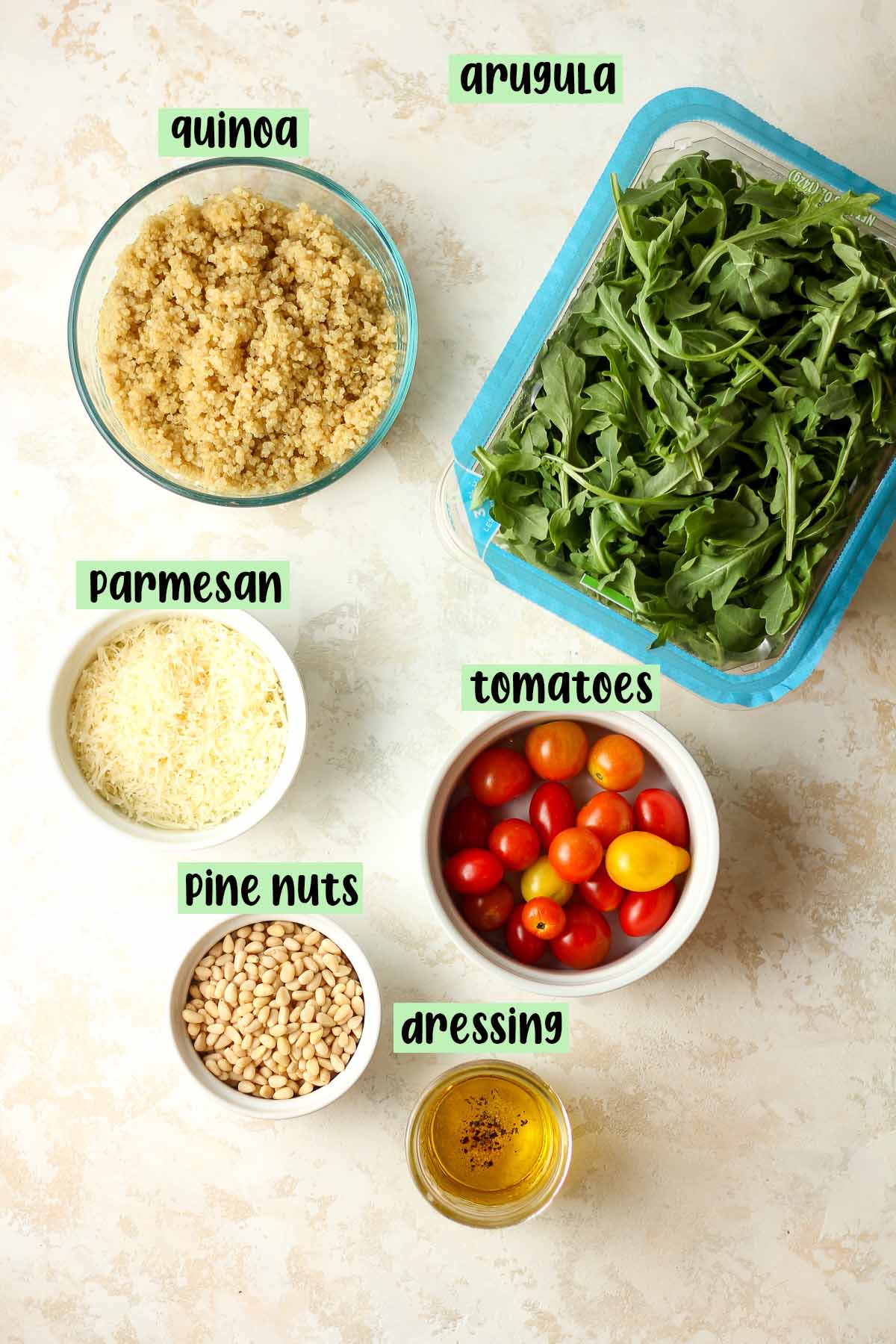 The labeled ingredients for the arugula quinoa salad.