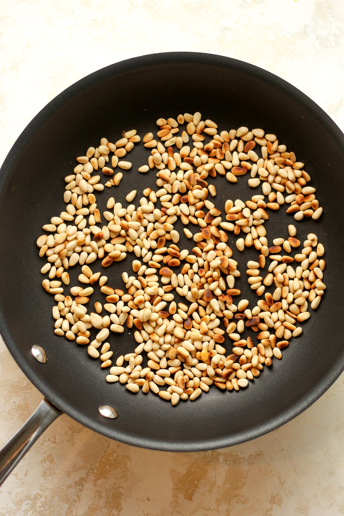 A pan of toasted pine nuts.