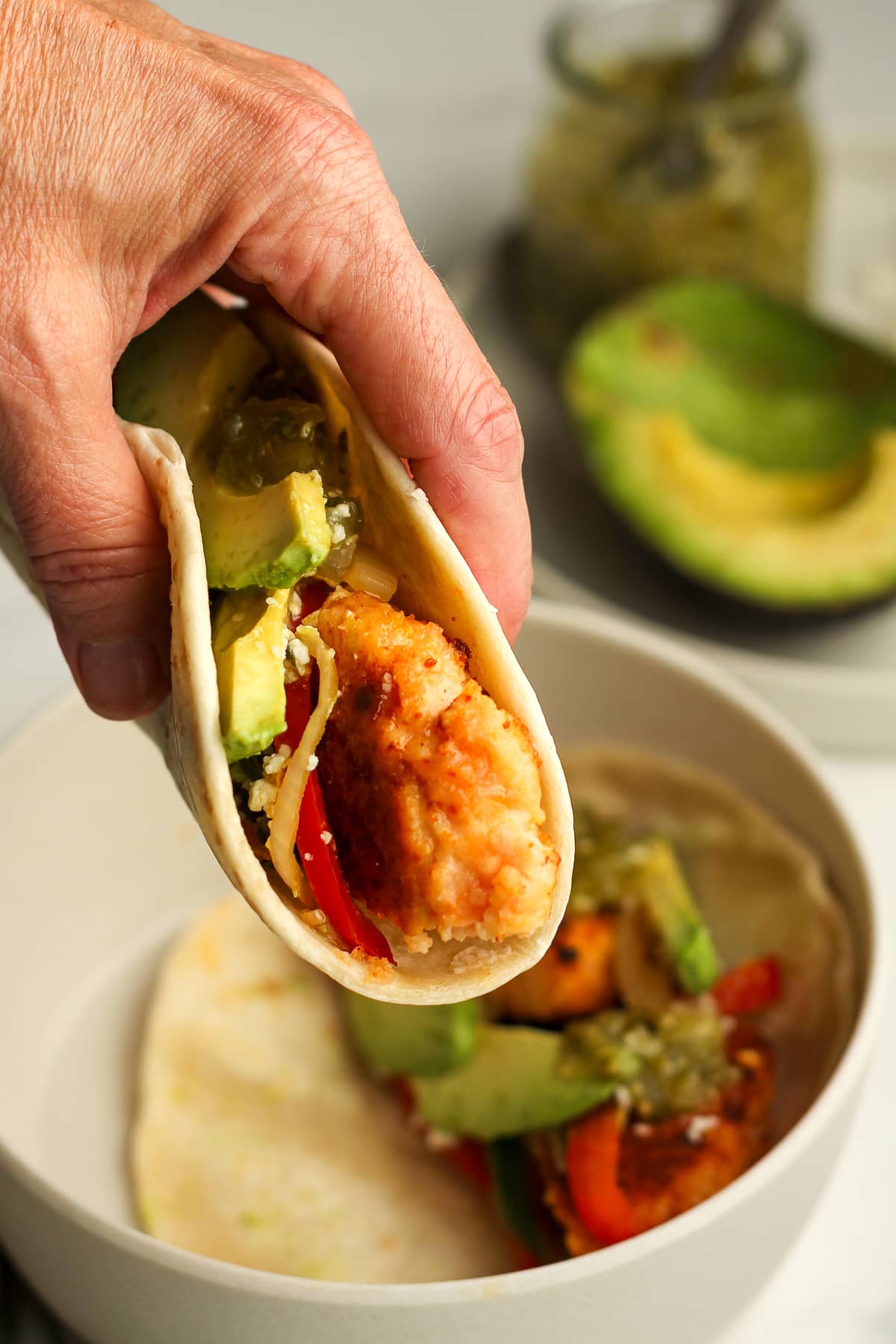 My hand holding a blackened salmon taco.