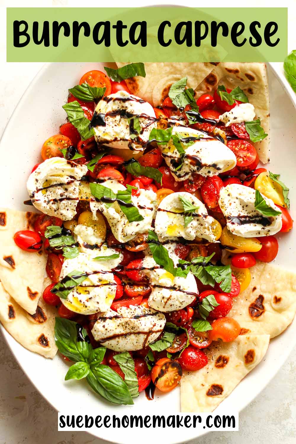 A platter of burrata caprese with fresh basil and balsamic.